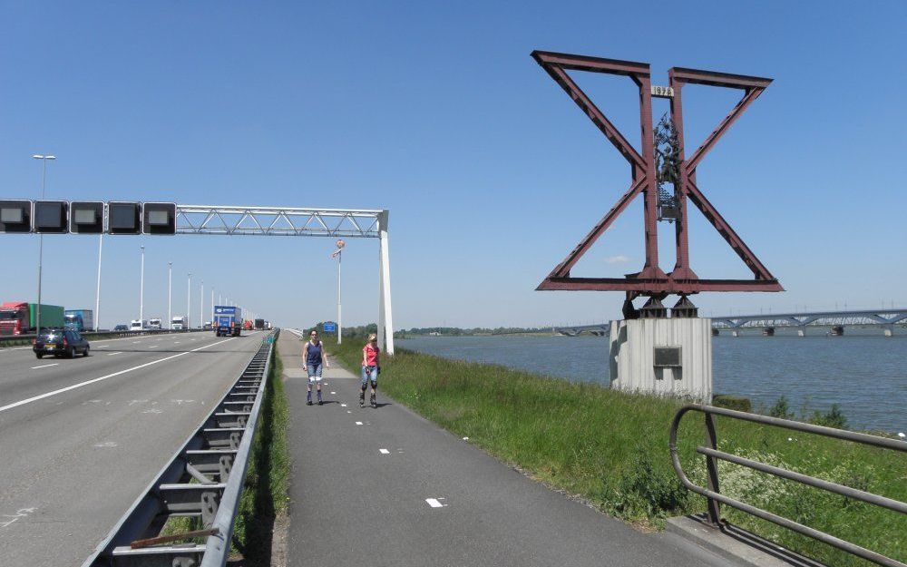 Het monument aan de zuidelijke kant van de Moerdijkbrug bestaat eigenlijk uit twee delen. De stalen driehoeken herinneren aan de ingebruikname van de nieuwe brug in 1978. Het bronzen reliëf op de stalen binten verwijst naar de ingebruikname van de eerste 