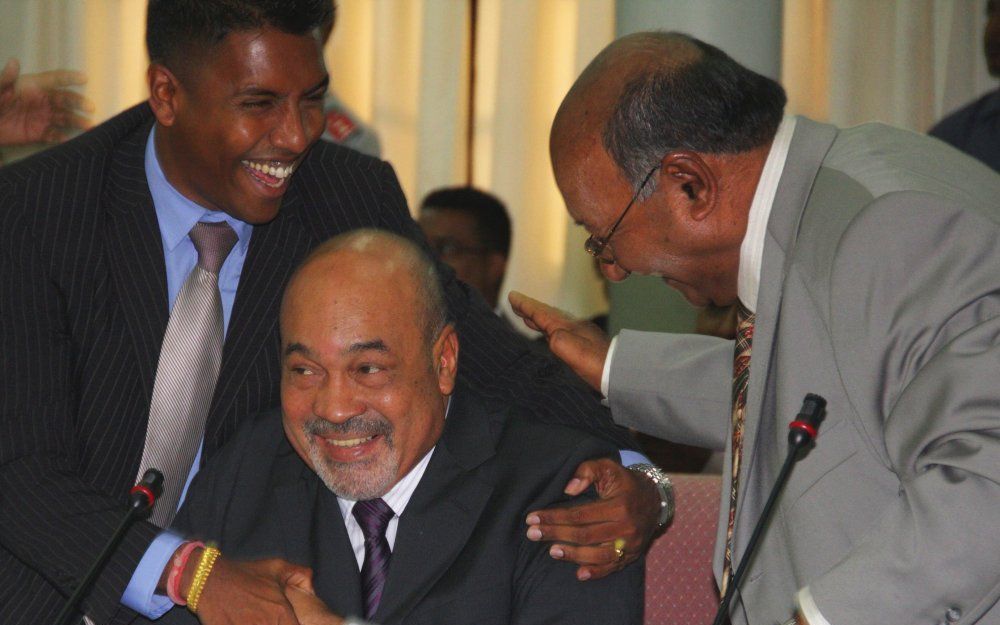 Desi Bouterse (M) ontvangt maandag in het parlementsgebouw van Suriname in Paramaribo de felicitaties van partijgenoten Harish Monorath (L) en Charles Pahlad (R). Foto EPA