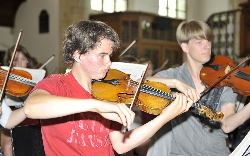 Het jeugdorkest uit het Engelse Suffolk bereidt zich voor op het concert donderdagavond in de Vlissingse Jacobskerk. Links eerste violist en concertmeester Elliot Bryant. Foto Rolf de Feijter/Provicom