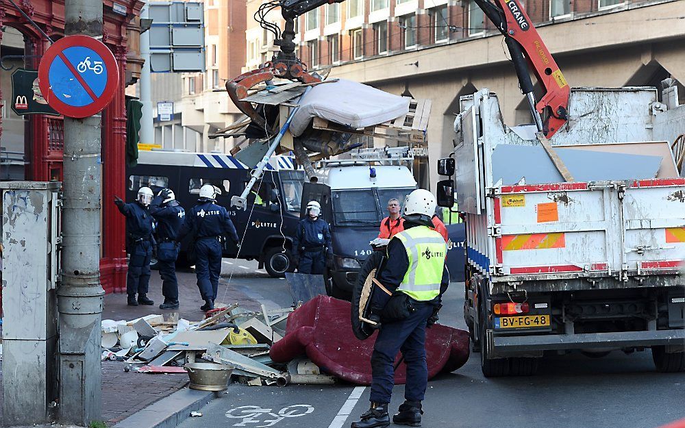 De huisraad van krakers wordt dinsdag met grote grijpers weggehaald uit de panden aan het Muntplein in Amsterdam. Foto ANP