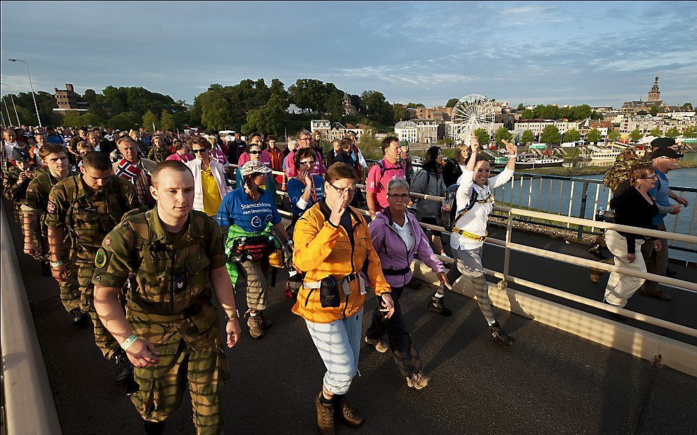 Op de eerste dag van de Vierdaagse in Nijmegen lopen de eerste wandelaars in alle vroegte over de Waalbrug. Foto ANP