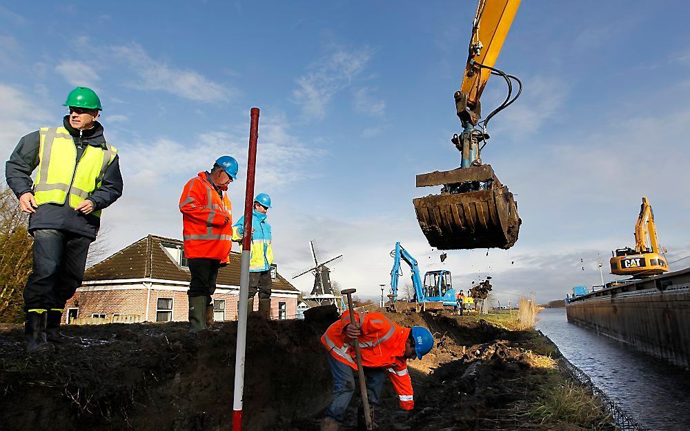 Aan de waterzijde tot aan de kruin wordt een zogenaamde kleikist aangebracht.  Foto ANP