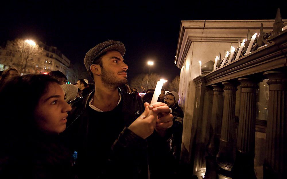 Joden branden maandagavond kaarsjes op de Place de la Bastille in Parijs. Foto EPA