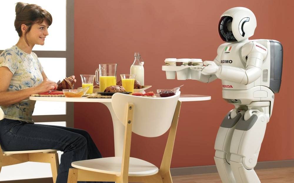 De humanoïde robot Asimo van Honda serveert koffie. Foto Honda