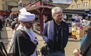 Tv-maker Jan Leyers in gesprek met moefti Pandor op de markt van Dewsbury, Noord-Engeland. Pandor is woordvoerder van de lokale Deobandi­gemeenschap, een ultraconservatieve stroming binnen de islam. De vrouw rechts is de nicht van Pandor. beeld VRT