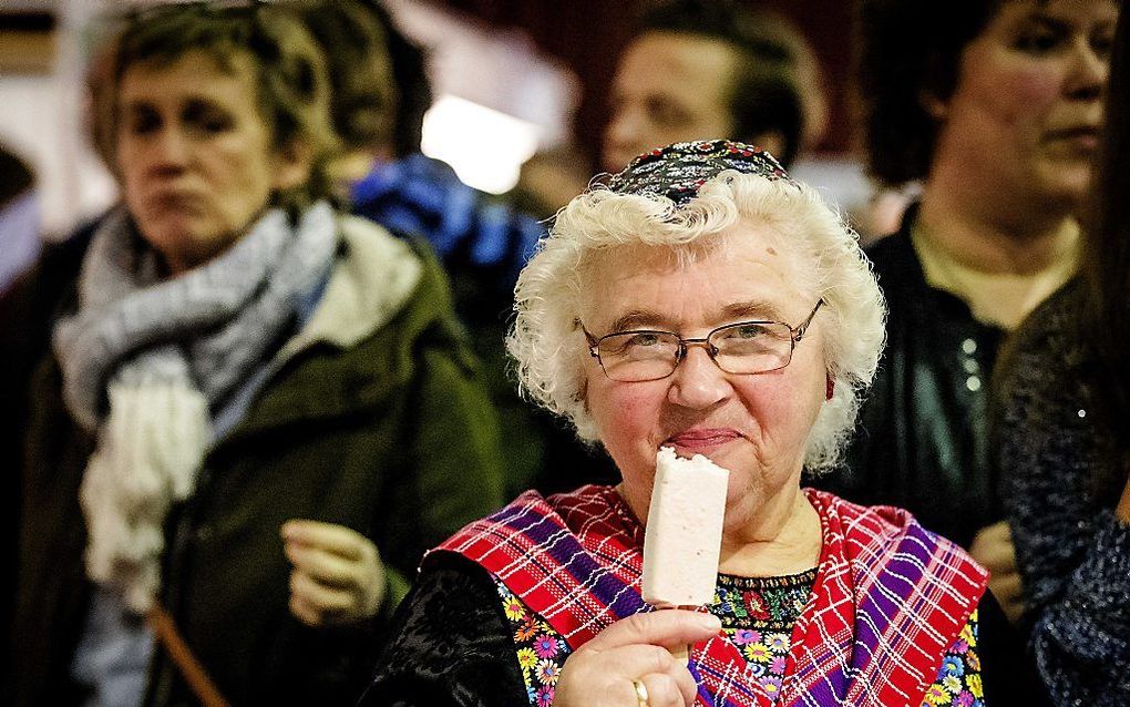 Een vrouw uit Staphorst laat zich een biologisch ijsje goed smaken. beeld ANP