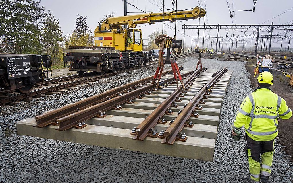 Werknemers werken aan een wissel op het spoor bij Hoofddorp. ProRail is bezig met grootscheepse werkzaamheden aan het spoor rond Schiphol en Amsterdam. beeld ANP