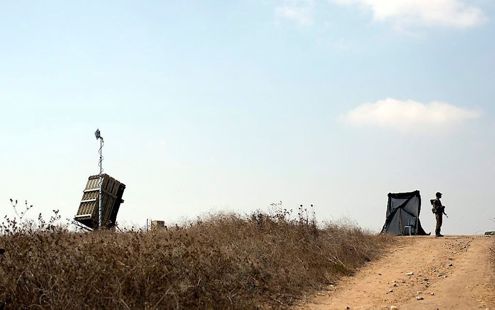 Een Israëlische militair voor een antiraketinstallatie van Iron Dome.  beeld EPA