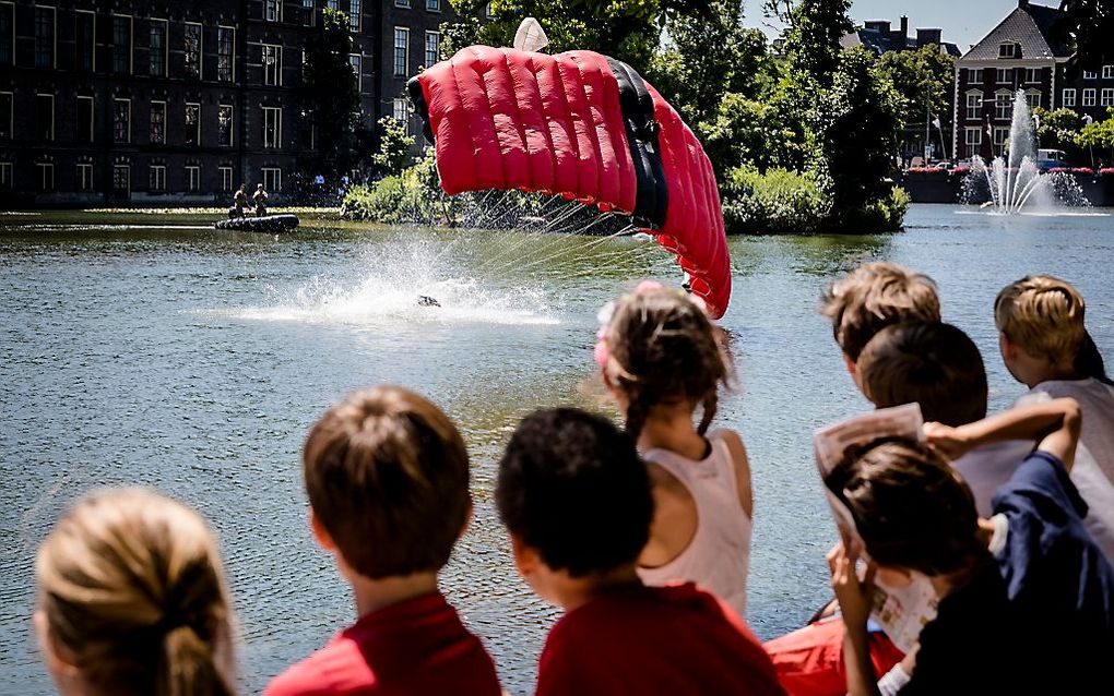 Parachutisten landden vrijdag tijdens een parajump in de Hofvijver in aanloop naar Veteranendag. beeld ANP