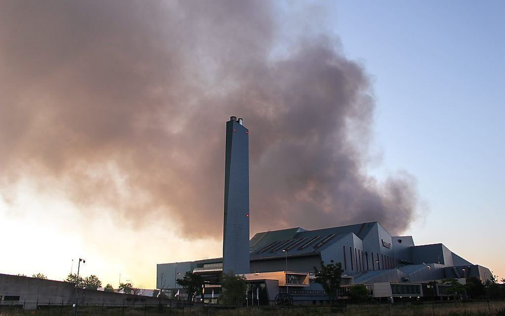 Een grote rookwolk boven het afvalverwerkingsbedrijf Twence waar eerder deze week een grote brand woedde in een afvalberg. beeld ANP