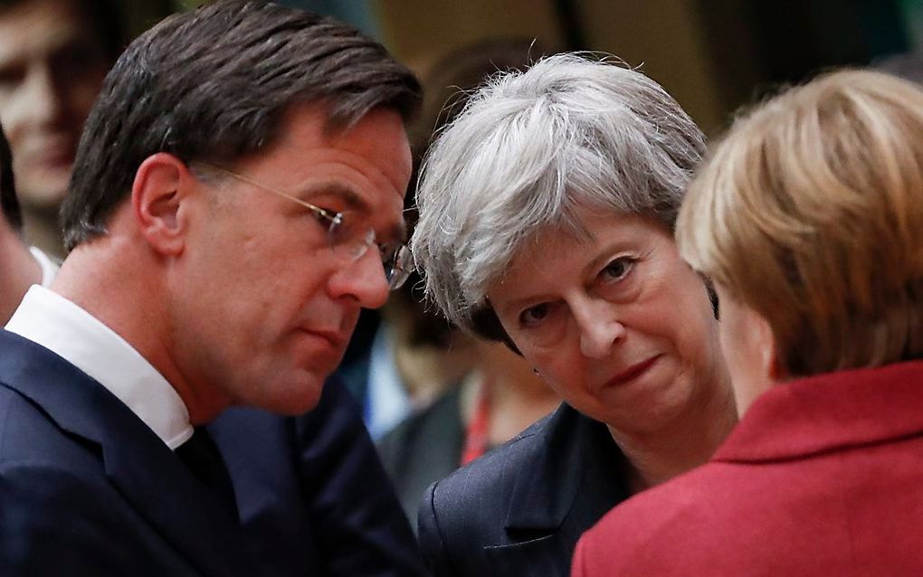 Rutte, May en Merkel. beeld EPA