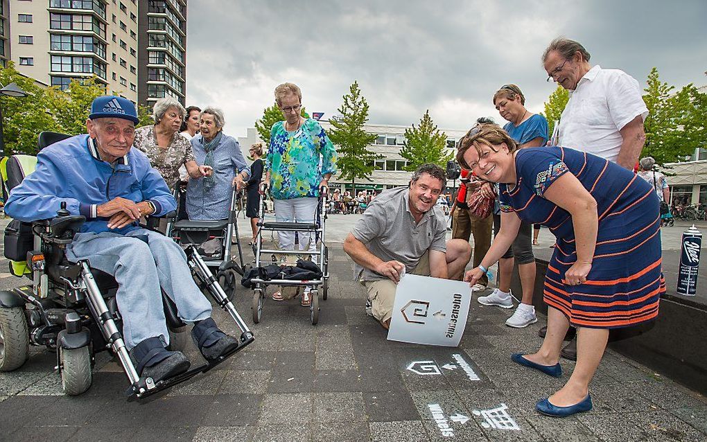 Stadsdeelbestuurder Esther Lagendijk onthult de laatste symbolen van de dementievriendelijke boodschappenroute in Amsterdam-Noord. beeld Richard Mouw