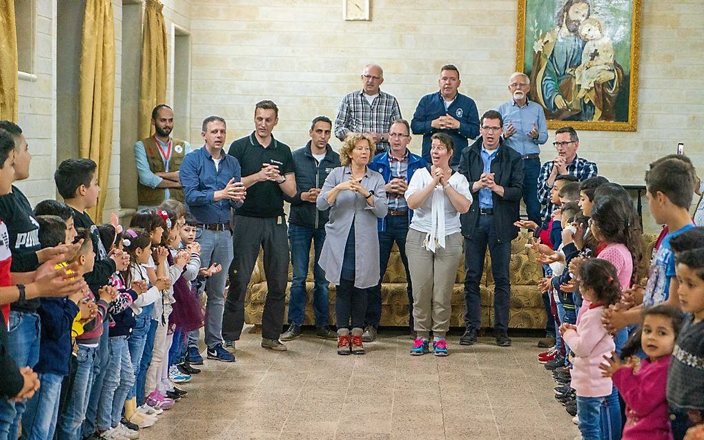 Nederlanders zingen de kinderen uit de kerk in Al-Shikhan toe. beeld Cees van der Wal