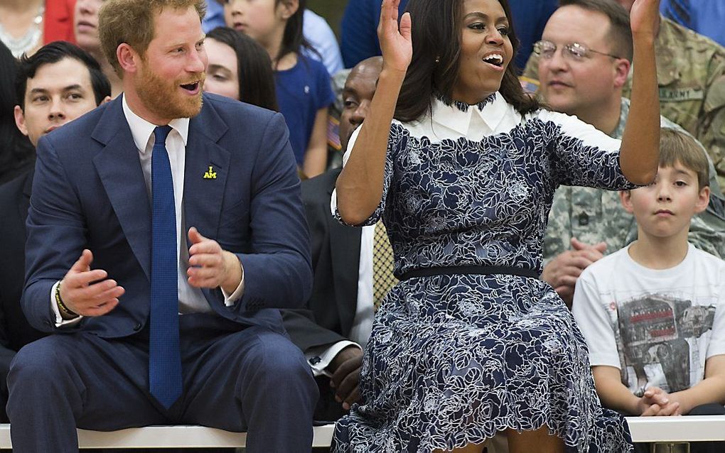 De Amerikaanse first lady Michelle Obama en de Britse prins Harry moedigen gehandicapte veteranen aan tijdens een basketbalwedstrijd van de Wounded Warriors. beeld AFP