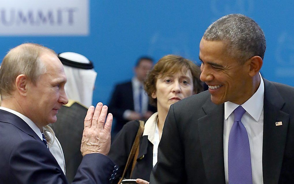 De Russiche president Poetin (L) en de Amerikaanse president Obama tijdens de G20. beeld AFP