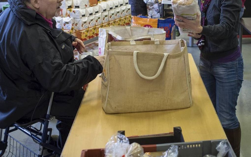 De 67-jarige Wim (l.) krijgt boodschappen van de voedselbank in Ede. Algemeen coördinator Hetty Lameris helpt hem. beeld Niek Stam