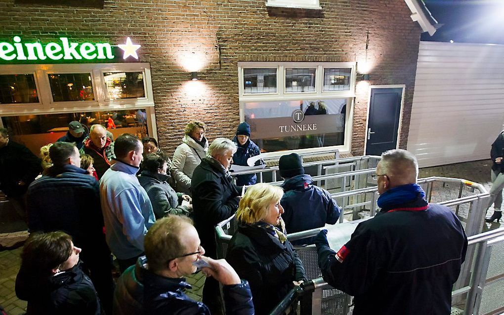 Bewoners die op een lijst staan worden toegelaten voor een informatiebijeenkomst waar inwoners van het Brabantse Heesch bijgepraat worden over de plannen voor een asielzoekerscentrum. Beeld ANP