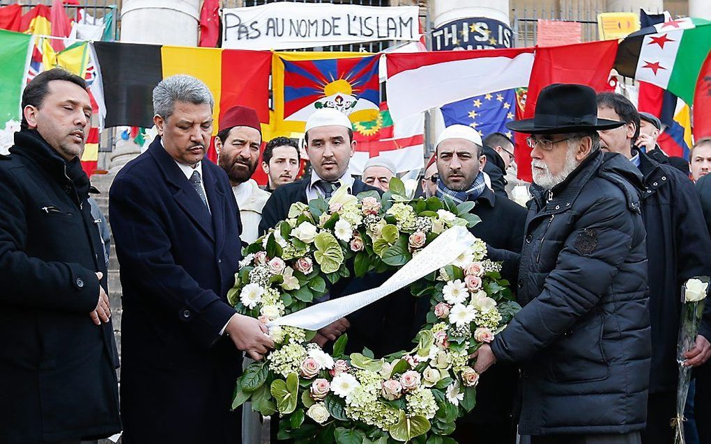 Salah Echallaoui (L) en Albert Guigui (R) leggene en krans in Brussel. beeld EPA