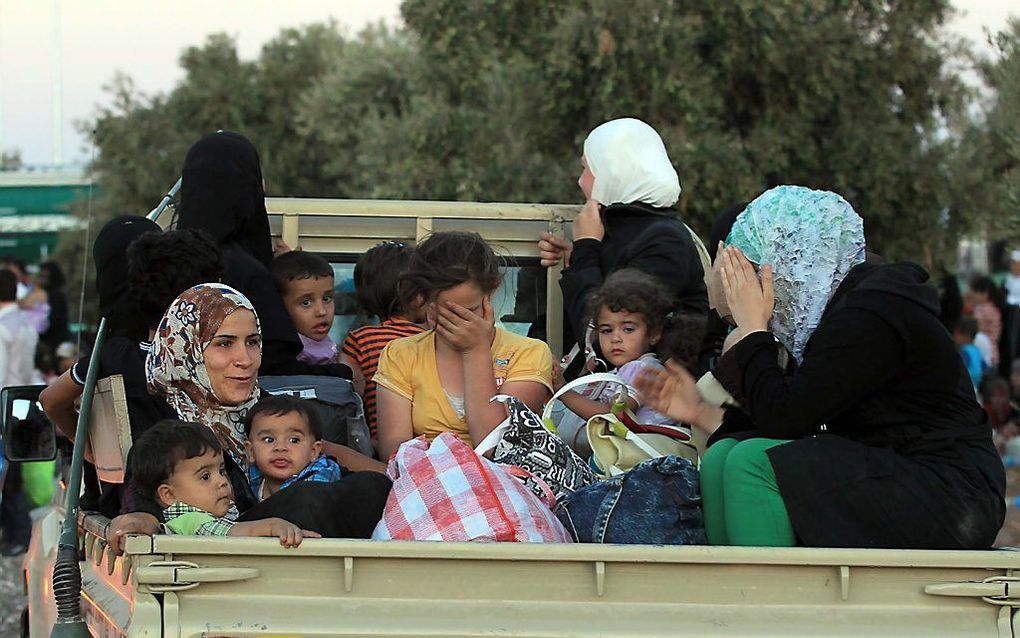 Een legertruck met Syrische vluchtelingen.  Foto EPA