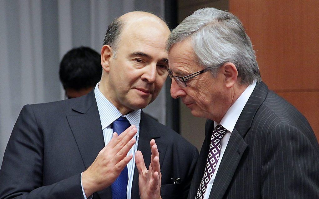 Links de Franse minister van Financiën, Pierre Moscovici, dinsdag in Brussel. Foto EPA