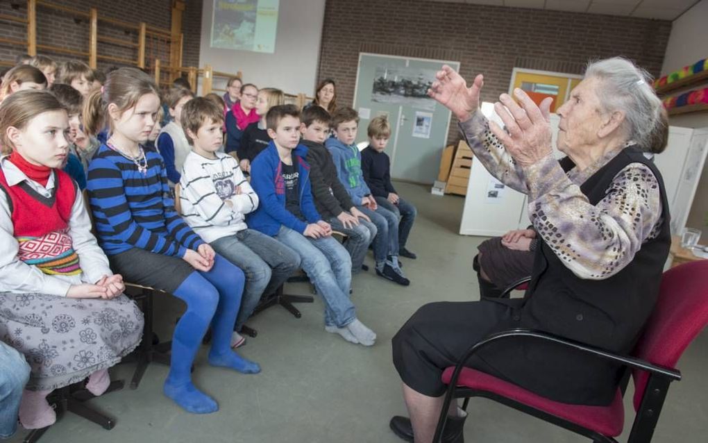 NIEUWERKERK – D. van Klinken-Kik, overlevende van de watersnood in 1953, vertelt haar verhaal aan leerlingen van de School met de Bijbel in Nieuwerkerk. „De hele zondag zaten we boven.” Foto Dirk-Jan Gjeltema