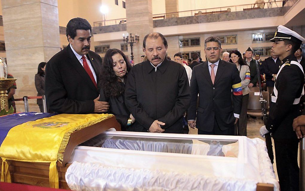 De Nicaraguaanse president Daniel Ortega (r.) en zijn vrouw Rosario Murillo (m.) nemen afscheid van Chavez. Foto EPA