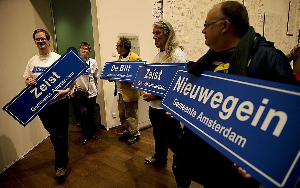 Inwoners van de provincie Utrecht demonstreren met plaatsnaamborden tegen de voorgenomen samenvoeging van de provincies Utrecht, Noord-Holland en Flevoland. Foto ANP