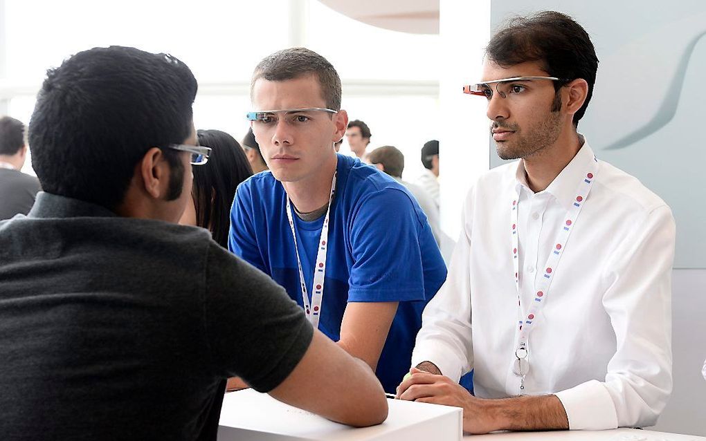 Twee bezoekers van de Google-conferentie dragen een Google Glass. Foto EPA