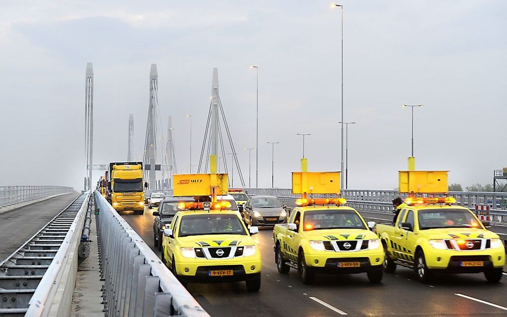 Auto's van de weginspecteurs rijden als eerste over de extra brug over de Waal op de A50. Foto ANP