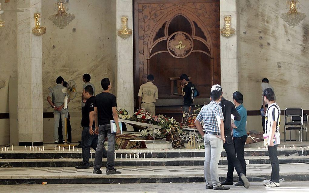 Ravage na de aanslag op een kerk in Bagdad in 2010. Beeld EPA