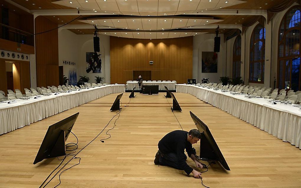 Een man maakt de zaal in Montreux gereed waar het vredesoverleg over Syrië zal plaatsvinden. Foto AFP