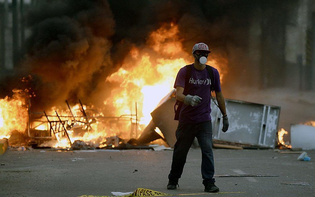 Een demonstrant in Caracas. Foto AFP