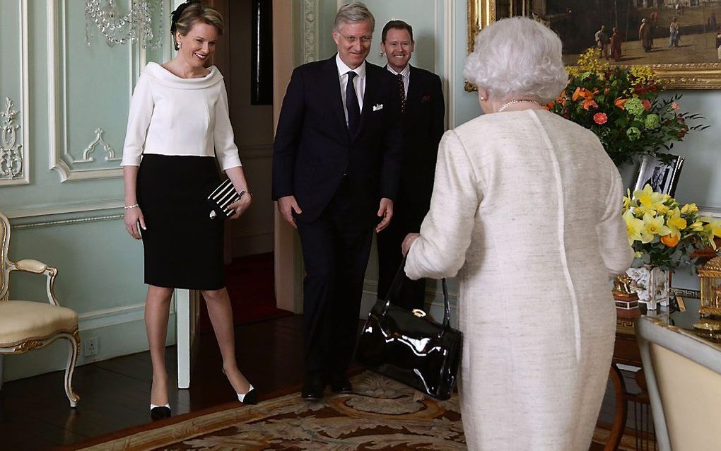 Koningin Elizabeth (r.), koning Filip (m.) en koningin Mathilde. beeld AFP