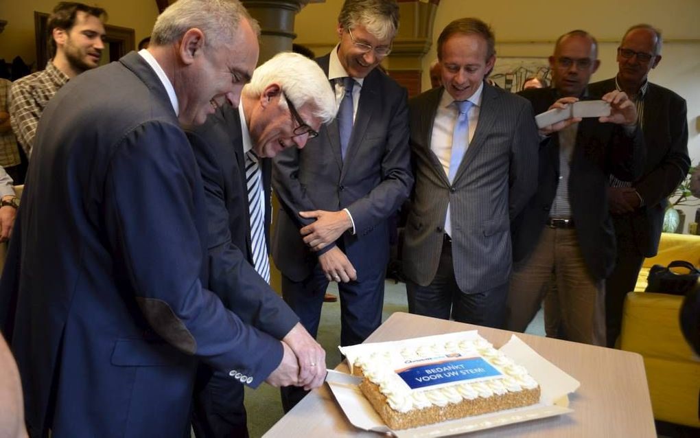 Europarlementariërs Van Dalen (ChristenUnie) en SGP’er Belder (r.) sneden maandagmorgen in de kamer van de ChristenUnievoorlichting in het Tweede Kamergebouw in Den Haag een taart aan ter gelegenheid van de uitslag van de Europese verkiezingen. Beide poli