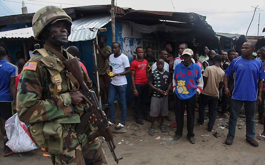 Een militair in de Liberiaanse stad Monrovia, waar ebola heerst. Beeld EPA