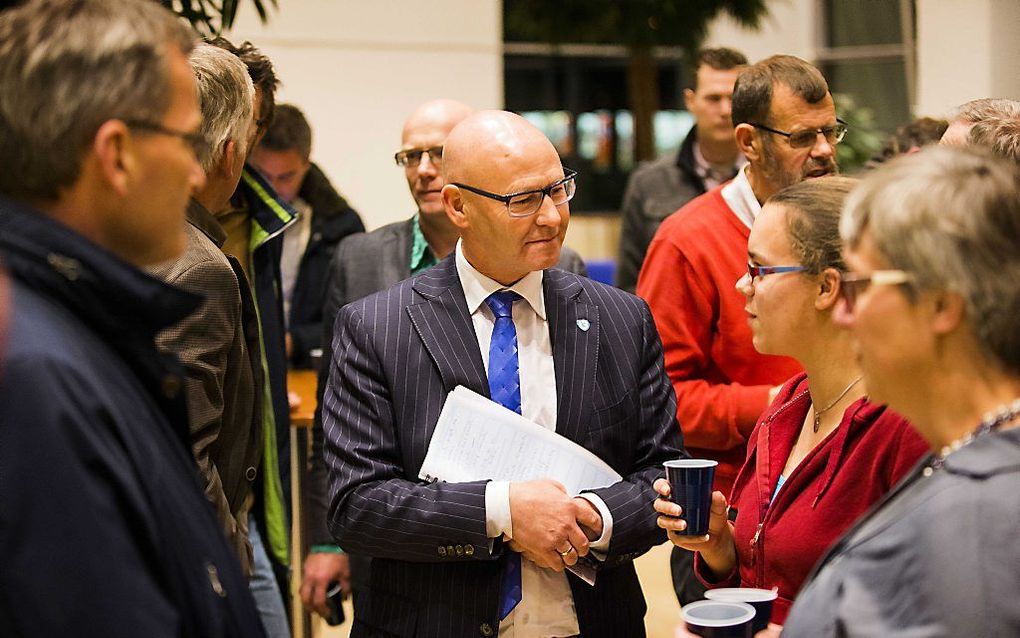 Burgemeester Koelewijn van Kampen praat tijdens een informatiebijeenkomst voor inwoners van Kamperveen met de buren van een getroffen kippenboer. beeld ANP