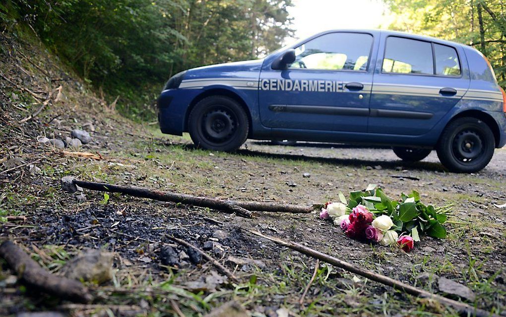 Bloemen op de plaats van de moord. Beeld AFP