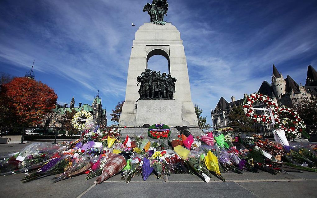 Bloemen bij het War Memorial in Ottawa, Canada. Op 24 oktober werd hier een ceremoniële erewacht doodgeschoten. Beeld AFP