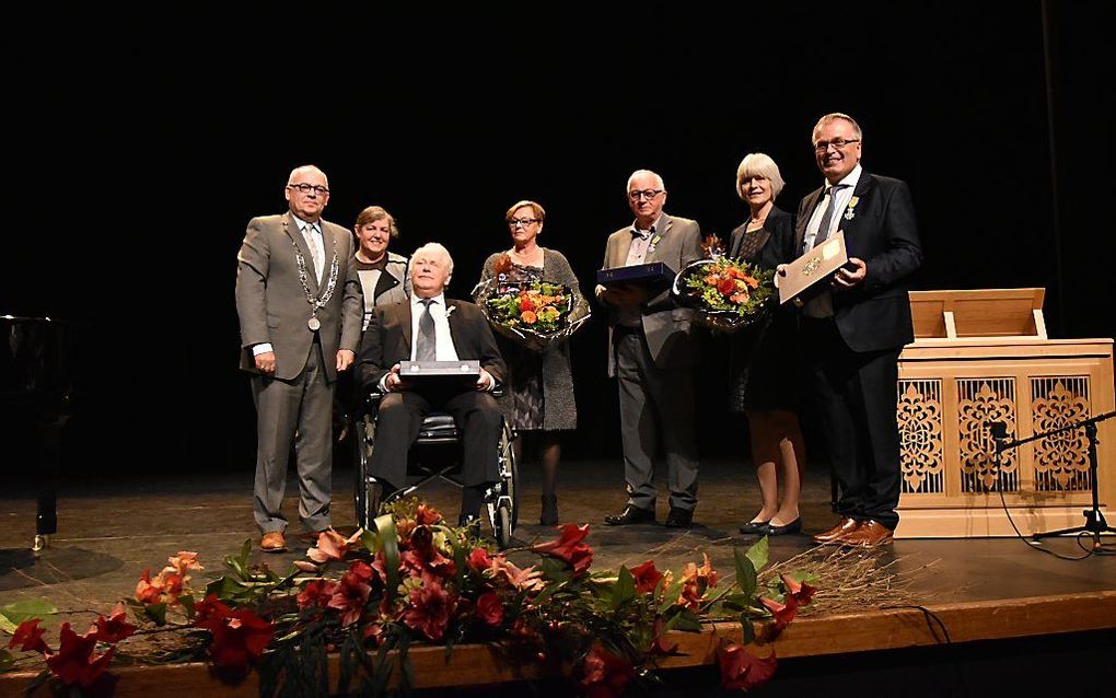 De gedecoreerden met hun echtgenotes en de burgemeester op het podium. Beeld Jan Willem Sanderman