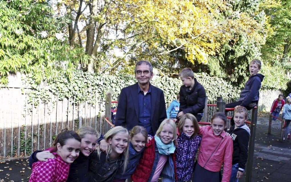 Schooldirecteur Hans Mijnders temidden van leerlingen van Rehobothschool in Ridderkerk. De vereniging die de school draagt bestaat 150 jaar. Beeld Dick den Braber