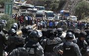 Politie en demonstranten stonden deze week tegenover elkaar bij een protestmanifestatie in Cochabamba, Bolivia. beeld EPA, Jorge Abrego