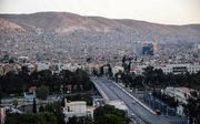 Zonsopgang zaterdagmorgen boven de Syrische hoofdstad Damascus. beeld EPA