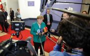 Ondanks de magere immigratiedeal toonde de Duitse bondskanselier Merkel zich donderdagnacht opmistisch. „We kunnen weer verder met elkaar”, was de boodschap. beeld AFP, Aris Oikonomou