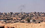 DEIR AL-ZOR. De Syrische oorlog lijkt op zijn einde te lopen. Maar op veel plaatsen wordt nog flink gevochten, zoals hier in Feir al-Zor. beeld AFP, George Ourfalian