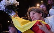 Feestende Colombianen na de bekendmaking van het vredesakkoord. Beeld AFP