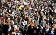 Iraniërs tijdens pro-overheid demonstraties vrijdag. beeld EPA