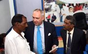 Peter van Dalen (m.) geeft de man van Asia Bibi in Pakistan bijbelteksten, kaarsen en andere tekens van bemoediging. beeld Jan Krelina, Europees Parlement