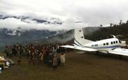 Vliegen op Papoea vraagt veel van de piloot. Het eiland wordt door kenners beschouwd als een van de gevaarlijkste regio’s ter wereld om te vliegen. Foto: inwoners van het dorp Ipdeheik bidden voor een veilige vlucht, foto Geerten Vreugdenhil
