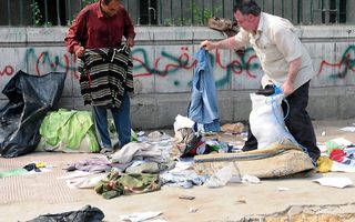 Mannen verzamelen achtergelaten kledingstukken in Caïro. Foto EPA