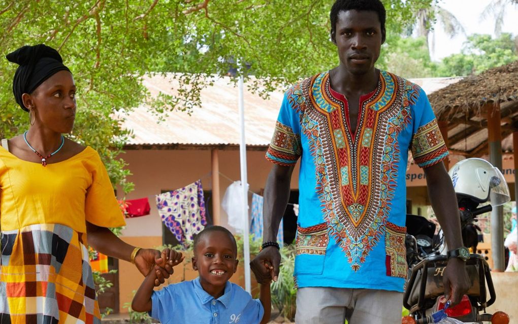 Adulai Balde (9) met zijn moeder Unumeme en therapeut Salomao Gomes bij hun vertrek van het trainingscentrum van Stichting Kimon/Jedidja in Buba, Guinee-Bissau. beeld Jaco Klamer